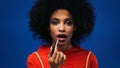 African american woman applying lip gloss Royalty Free Stock Photo
