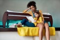 Moments. African american woman, baby sitter and caucasian cute little girl reading book, fairy tale together while Royalty Free Stock Photo