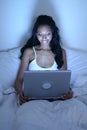 African American woman in bed with laptop Royalty Free Stock Photo