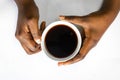 African American woman both hands holding a white cup of coffee. Black Female hands holding a hot cup of coffee with foam