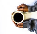 African American woman both hands holding a white cup of coffee. Black Female hands holding a hot cup of coffee with foam Royalty Free Stock Photo