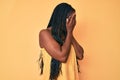 African american woman with braids wearing casual clothes with sad expression covering face with hands while crying Royalty Free Stock Photo