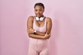 African american woman with braids wearing sportswear and headphones shaking and freezing for winter cold with sad and shock Royalty Free Stock Photo