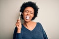 African american woman brushing her teeth using tooth brush and oral paste, cleaning teeth and tongue as healthy health care Royalty Free Stock Photo