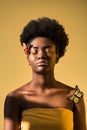 African american woman with butterflies with closed eyes isolated on brown