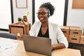 African american woman call center agent smiling confident holding question mark reminder paper at office Royalty Free Stock Photo