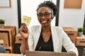 African american woman call center agent smiling confident holding yes reminder paper at office Royalty Free Stock Photo