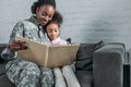 African american woman in camouflage clothes and child