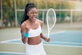 African american woman cheering after a tennis match. Young woman celebrating her success after a tennis match. Young Royalty Free Stock Photo