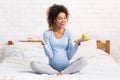 African-american woman choosing between healthy and junk food Royalty Free Stock Photo