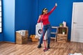 African american woman cleaning floor dancing at laundry room Royalty Free Stock Photo