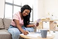 African american woman counting money at home