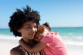 African american woman with daughter at beach enjoying summer weekend together Royalty Free Stock Photo