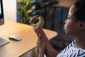 African American woman deals with prevention of carpal tunnel syndrome using expander while working