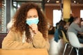 African-American woman with disposable mask. Virus protection