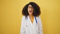 African american woman doctor angry screaming over isolated yellow background Royalty Free Stock Photo