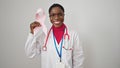 African american woman doctor holding breast cancer awareness pink ribbon over isolated white background Royalty Free Stock Photo