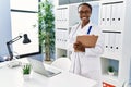 African american woman doctor smiling confident holding medical report at clinic Royalty Free Stock Photo