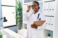 African american woman doctor smiling confident holding medical report at clinic Royalty Free Stock Photo