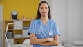 African american woman doctor standing with serious expression and arms crossed gesture at clinic Royalty Free Stock Photo