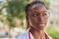 African american woman doctor standing with serious expression at park Royalty Free Stock Photo