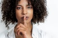 African american woman doing gesture of silence with finger and lips Royalty Free Stock Photo