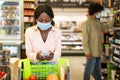 African American Woman Doing Grocery Shopping Using Smartphone In Supermarket Royalty Free Stock Photo