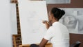 African american woman drawing professional sketch on canvas Royalty Free Stock Photo