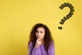 African American woman with drawing of question mark on background Royalty Free Stock Photo