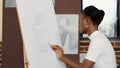 African american woman drawing vase model on white canvas Royalty Free Stock Photo