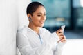 African american woman with earphones and phone