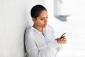 African american woman with earphones and phone