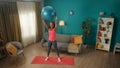 African American woman exercising with a fitness ball. An athletic woman raised a fitball over her head on straight