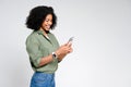 African-American woman exudes casual elegance as she reads content on her smartphone Royalty Free Stock Photo