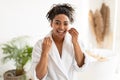 African American Woman Flossing Teeth Smiling To Camera In Bathroom Royalty Free Stock Photo