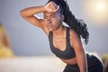 African American woman focused on her health and fitness. Serious young female starting her workout and cardio exercise