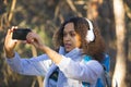 African American woman in the forest taking a photo on a smartphone. Royalty Free Stock Photo