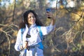 African American woman during the forest travel taking a selfie on a smartphone. Royalty Free Stock Photo