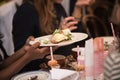 African-American woman getting breakfast food on Sunday brunch in restaurant