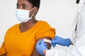 African American Woman Getting Vaccinated Against Covid-19, White Background, Cropped