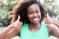 African american woman in a green shirt showing both thumbs Royalty Free Stock Photo