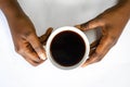 African American woman hands holding a white cup of coffee. Black Female hands holding a hot cup of coffee with foam Royalty Free Stock Photo