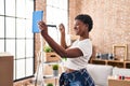 African american woman having video call holding key at new home Royalty Free Stock Photo