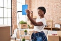 African american woman having video call holding key at new home Royalty Free Stock Photo