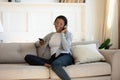 African American woman in headphones using smartphone gadget Royalty Free Stock Photo
