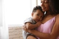 African-American woman  her baby at home. Happiness of motherhood Royalty Free Stock Photo