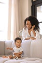 African-American woman with her baby in room. Happiness of motherhood Royalty Free Stock Photo