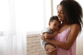 African-American woman with her  at home. Happiness of motherhood Royalty Free Stock Photo