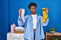African american woman holding clean andy dirty socks skeptic and nervous, frowning upset because of problem Royalty Free Stock Photo