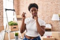 African american woman holding keys of new home serious face thinking about question with hand on chin, thoughtful about confusing Royalty Free Stock Photo